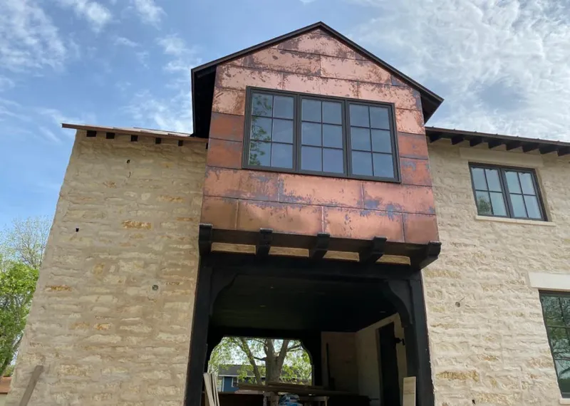 Copper metal panel facade on a stone building for Skylight Installation in Northborough